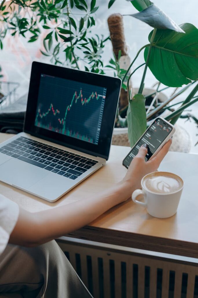 Businessperson Using Her Smartphone and Laptop